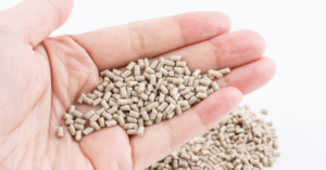 Recycled PEEK Pellets Used in High-Performance Manufacturing Hand holding recycled PEEK polymer pellets used in high-performance industrial manufacturing
